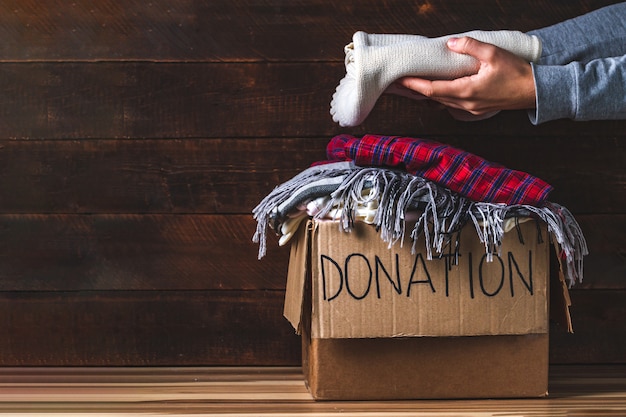 Photo donation concept. donation box with donation clothes. charity. helping poor and needy people