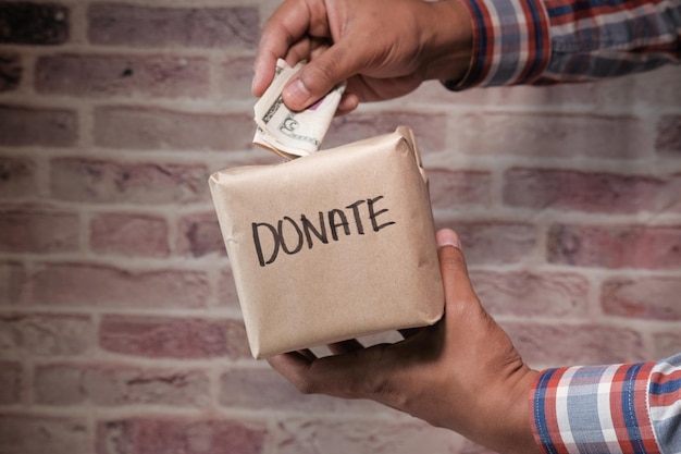 Photo donation concept man holding a donate box for giving