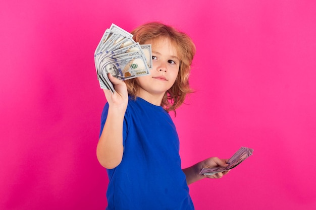 Donation saving charity and finance concept Child with money dollar bills standing dreamy of rich against isolated studio background