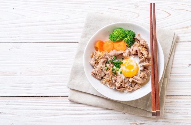 donburi, pork rice bowl with onsen egg and vegetable