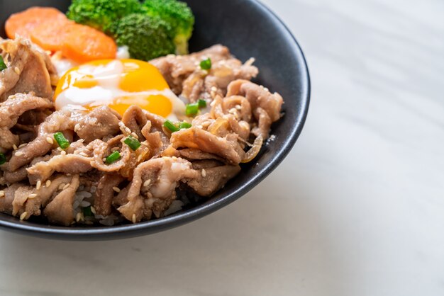 donburi, pork rice bowl with onsen egg and vegetable