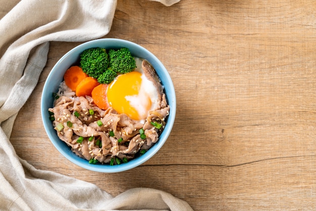 donburi, pork rice bowl with onsen egg and vegetable