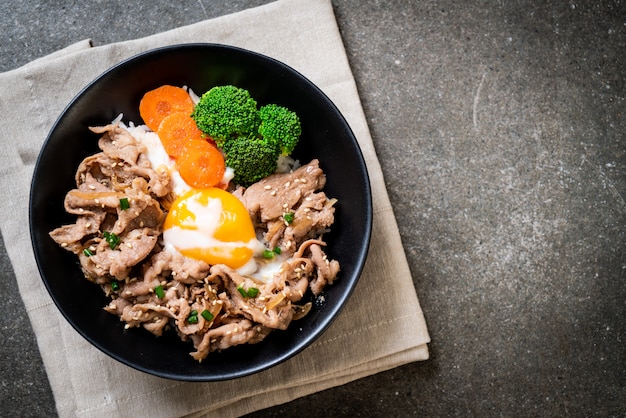 donburi, pork rice bowl with onsen egg and vegetable