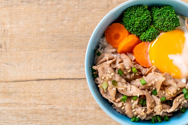 donburi, pork rice bowl with onsen egg and vegetable