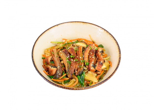 Donburi Unagi or eel slices with rice, vegetables in ceramic bowl