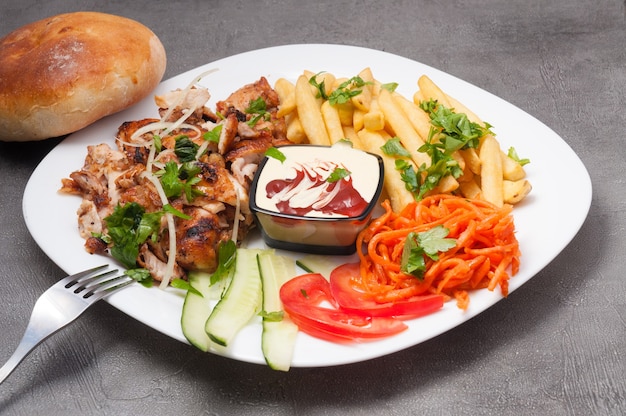 Doner kebab or shawarma on a plate with french fries