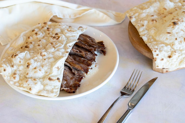 Doner kebab with rice on plate on white background