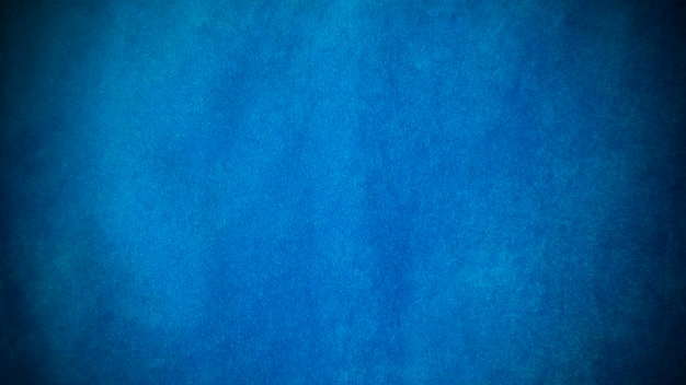 Donkerblauwe fluwelen stoftextuur gebruikt als achtergrond Lege donkerblauwe stofachtergrond van zacht en glad textielmateriaal Er is ruimte voor tekst