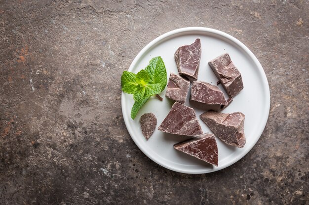 Donkere chocoladestukjes geplet op een donkere achtergrond bovenaanzicht