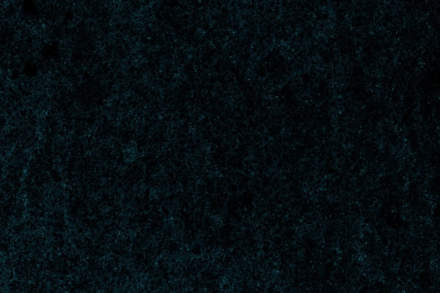 Donkere cyaan kleur verspreide grunge textuur op geïsoleerd zwart papier voor achtergrond