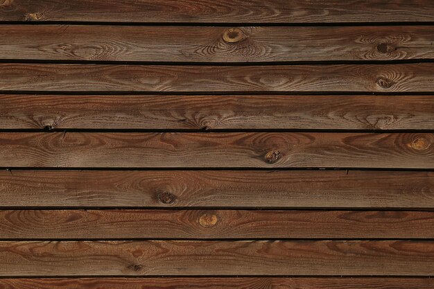 Foto donkere houten structurele achtergrond van oude planken met knopen