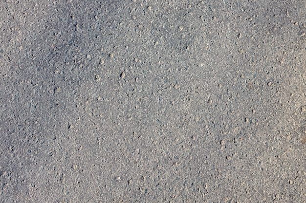 Donkergrijs grunge ruw oppervlak van asfalt