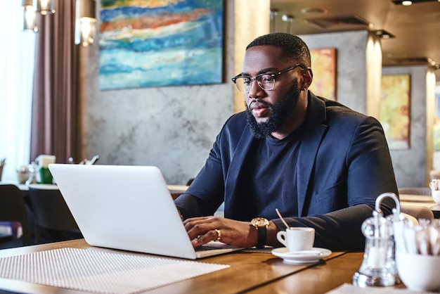 Dont complain and do your best african american businessman is working using his laptop while