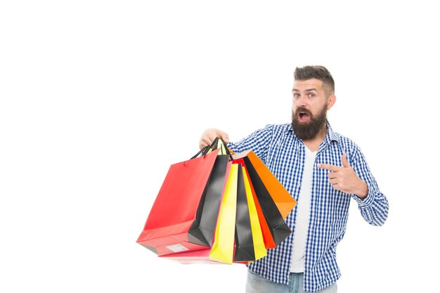 Dont miss the sale Bearded man pointing finger at shopping bags after seasonal sale isolated on white Surprised hipster buying at sale price Black Friday and cyber monday sale copy space