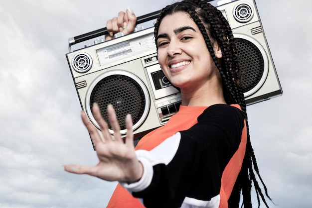 Dont stop me now Cropped portrait of an attractive young female dancer standing with her boombox against a stormy backdrop