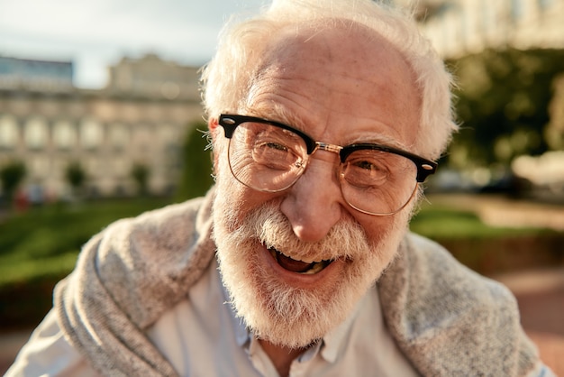 Dont worry about getting older portrait of handsome bearded senior man in glasses looking at camera