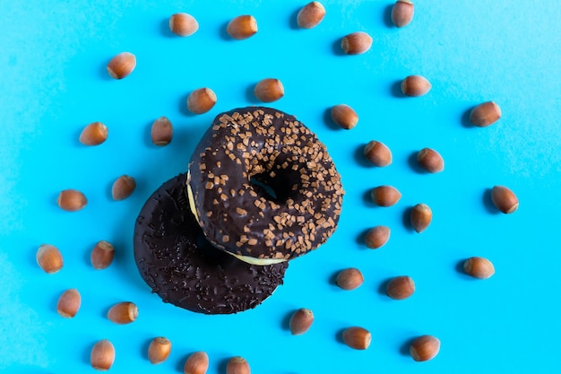 Donut met hazelnoten op blauwe achtergrond, close-up