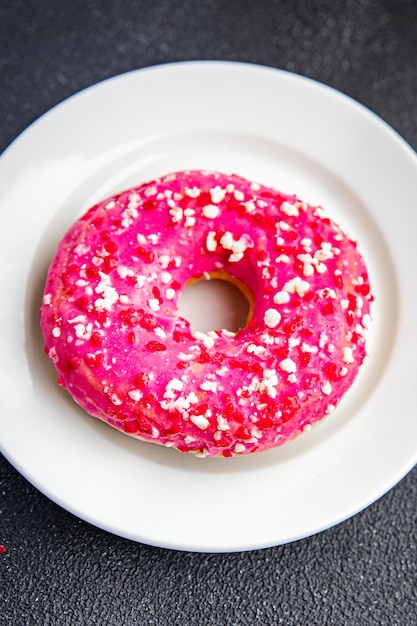 donut pink icing sweet dessert fresh portion healthy meal food diet snack on the table copy space