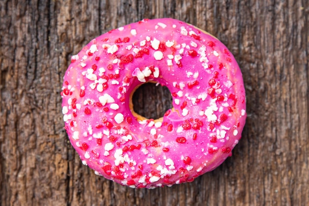 donut pink icing sweet dessert fresh portion healthy meal food diet snack on the table copy space