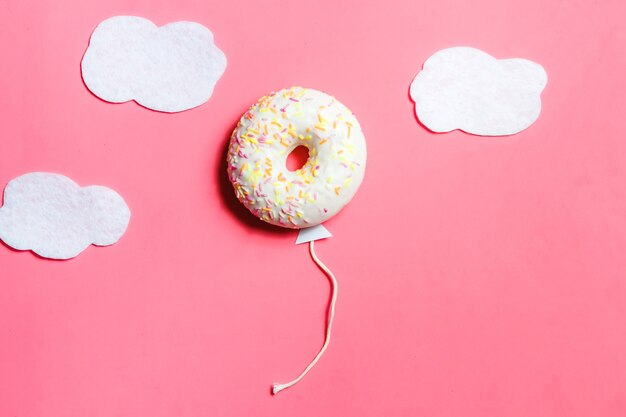 Donut in Shape of Balloon in Sky with Clouds