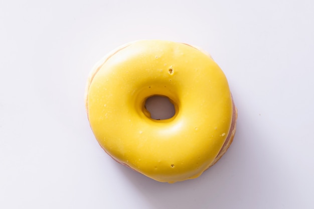 Photo donut with banana filling lies isolated on white