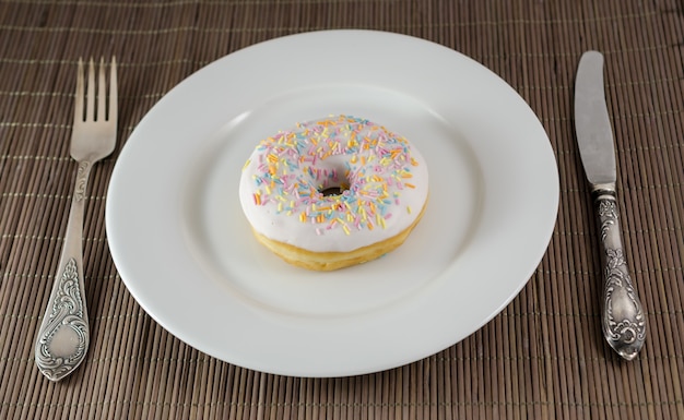 Donut with knife and fork