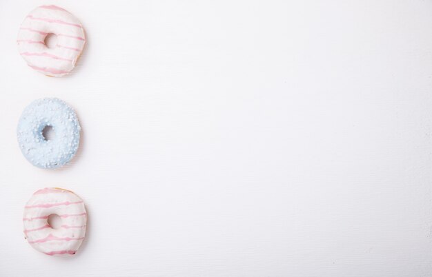 Donuts in colored glazes on a white background.Pastries,dessert