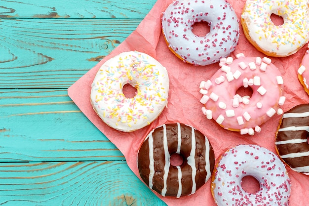 Donuts on colorful wooden table