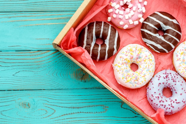 Donuts on colorful wooden table