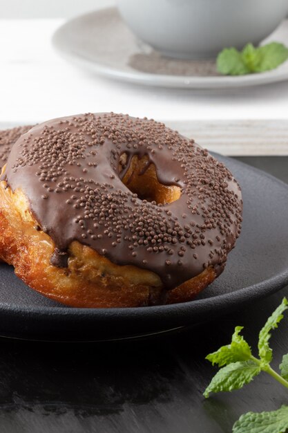 Donuts covered with chocolate and stuffed with dulce de leche, selective focus.