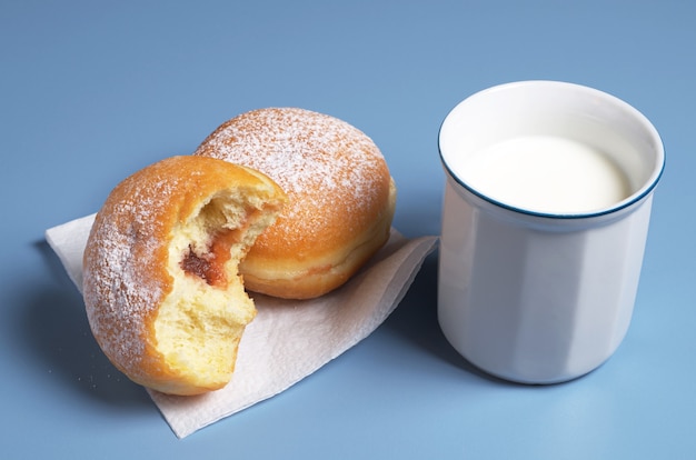 Donuts and cup of milk for breakfast on the table