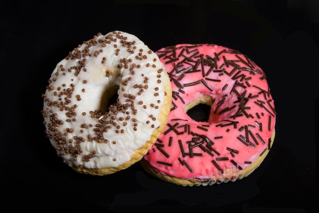 Donuts in glaze on a black background