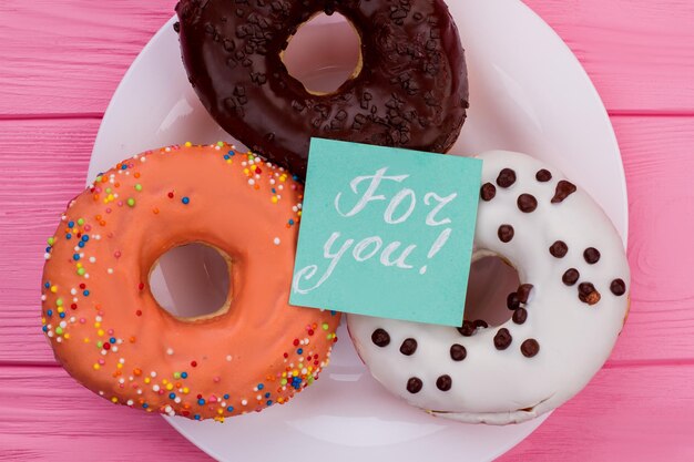 Donuts on plate and paper card.