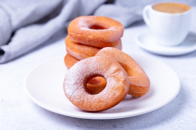 Donuts in the shape of a ring fried in oil