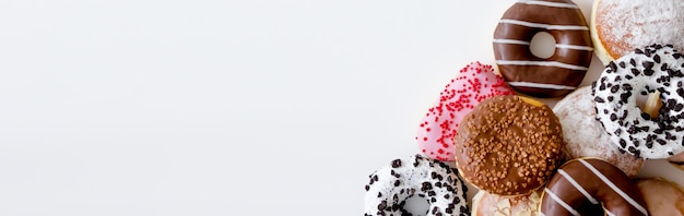 donuts with colorful icing on a white background place for text