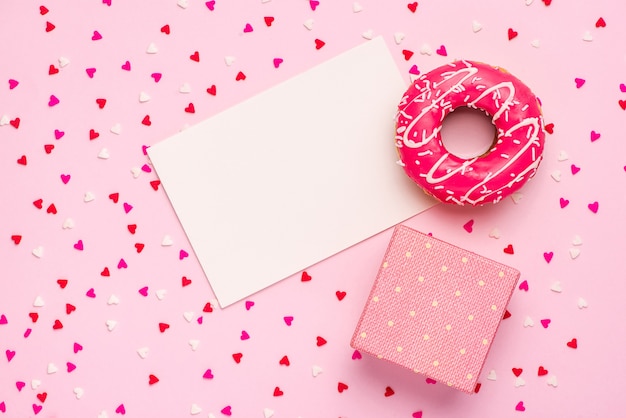 Photo donuts with icing on pastel pink background with copyspace. sweet donuts.