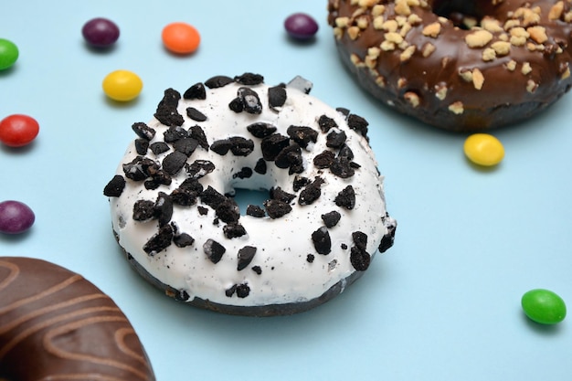 Donuts with sprinkles on a blue background close up