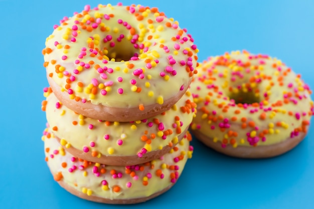 Donuts with sprinkles on blue background.