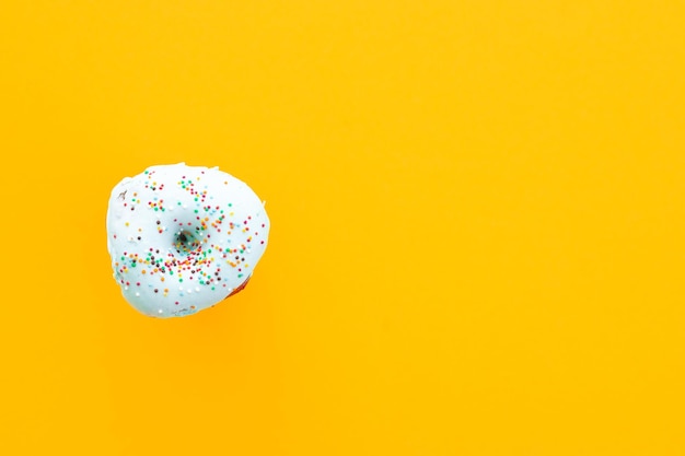 Donuts with sprinkles isolated on yellow background