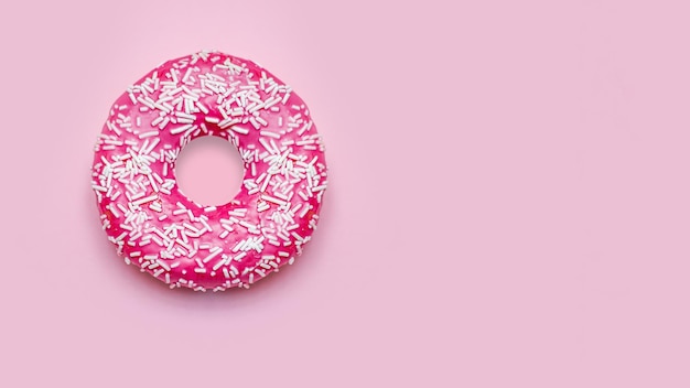 Donuts with sprinkles on a pink background