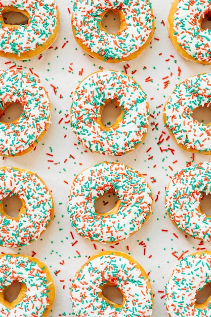 Donuts with white chocolate cream and sprinkles sugar