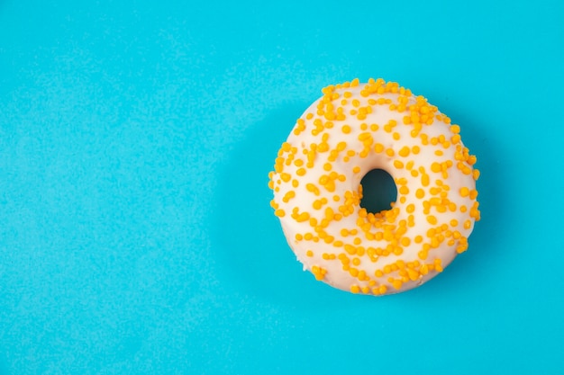 Donuts with white glaze, on a blue