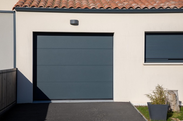 Door gray modern on facade white closed new garage home gate at entrance of private house