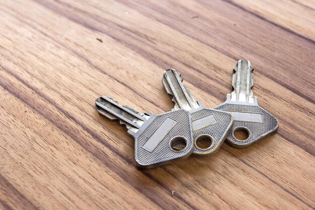 Door keys on wooden background