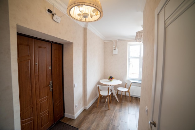 A door leading to a room with a table and chairs