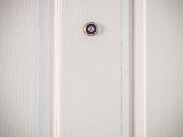 Door lens peephole security on wooden texture