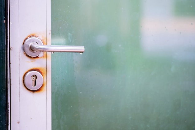 Door with old latch handle close up