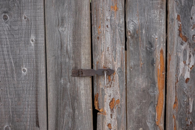 Doors or barn doors made of planks that can be pulled to the side along a skid rail the door hangs on a hinge with wheels retractable shutters made of wood on the cottage