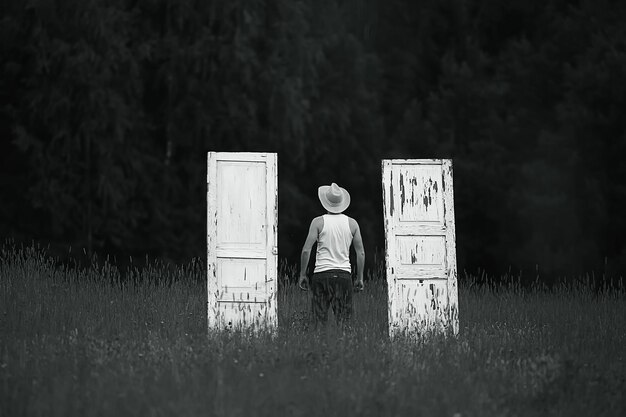 Doors in the field and farmer, concept of unusual choice for Halloween