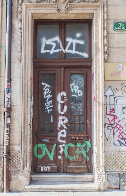 Photo doors of an old house in slovenia painted by graffiti